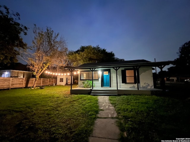 single story home featuring covered porch and a front yard