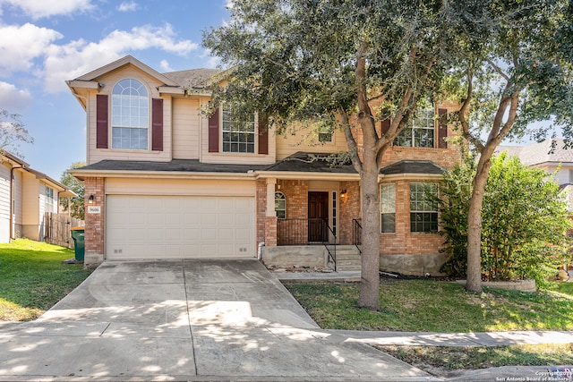 view of property featuring a garage and a front lawn