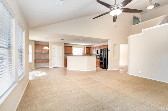 9606 Mediator Run, Converse, TX 78109 - unfurnished living room featuring a ceiling fan, baseboards, light colored carpet, high vaulted ceiling, and arched walkways