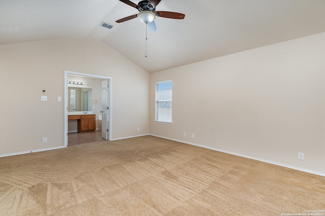 empty room with ceiling fan, light carpet, and vaulted ceiling