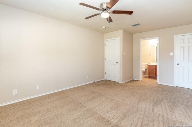 9606 Mediator Run, Converse, TX 78109 - unfurnished bedroom featuring light colored carpet, baseboards, connected bathroom, and a ceiling fan