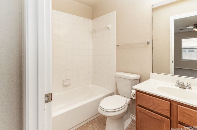 full bathroom featuring vanity, ceiling fan, tile patterned flooring, toilet, and tiled shower / bath