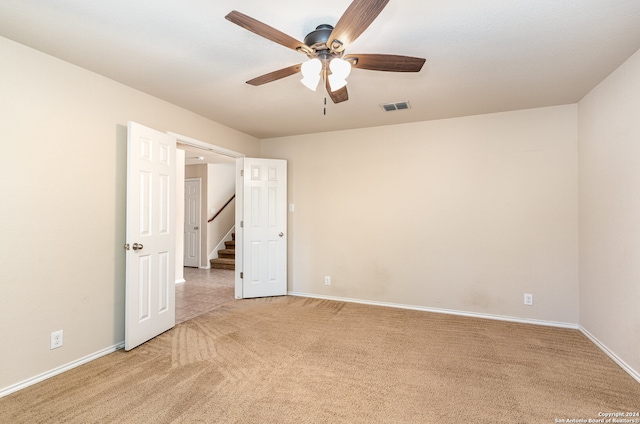 unfurnished room featuring ceiling fan and light colored carpet