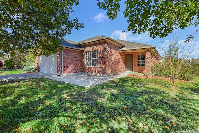 single story home featuring a garage and a front lawn