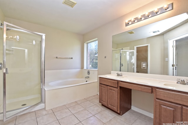 bathroom featuring tile patterned floors, vanity, and shower with separate bathtub