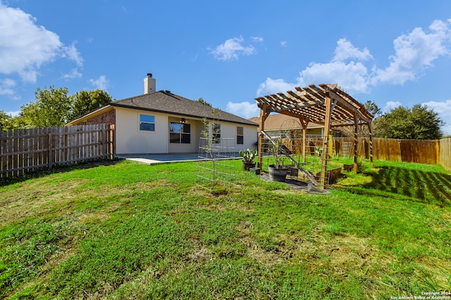 rear view of house with a patio area, a pergola, and a yard