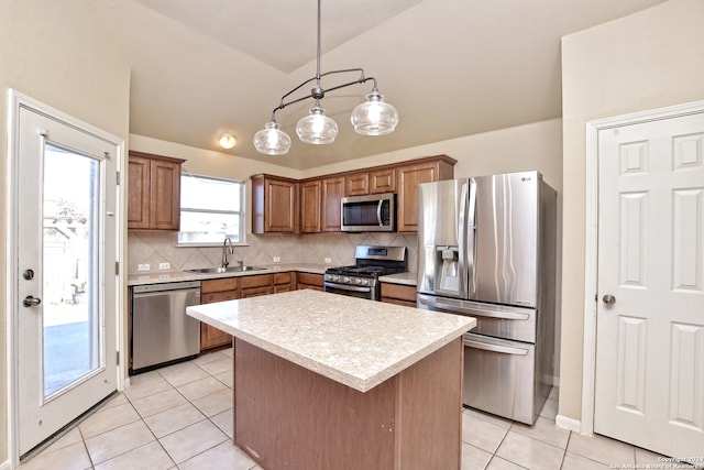 kitchen with sink, a center island, decorative light fixtures, decorative backsplash, and appliances with stainless steel finishes