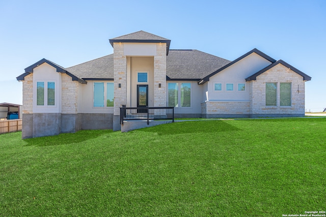 rear view of house featuring a yard