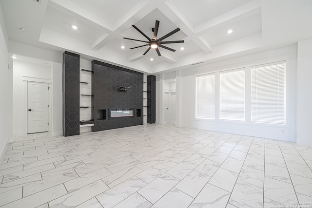 unfurnished living room with beamed ceiling, ceiling fan, a fireplace, and coffered ceiling