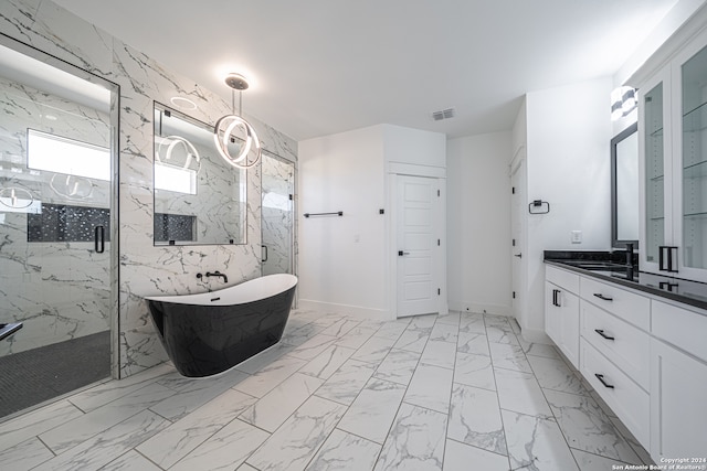 bathroom featuring vanity, separate shower and tub, and tile walls