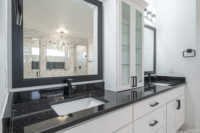 bathroom with vanity and a shower with shower door