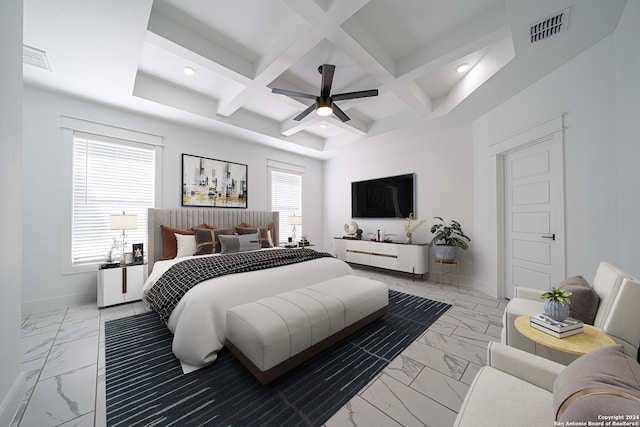 bedroom with beam ceiling, multiple windows, coffered ceiling, and ceiling fan