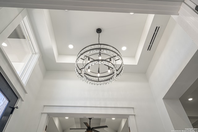 details with ceiling fan with notable chandelier