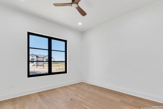 empty room featuring ceiling fan and light hardwood / wood-style floors