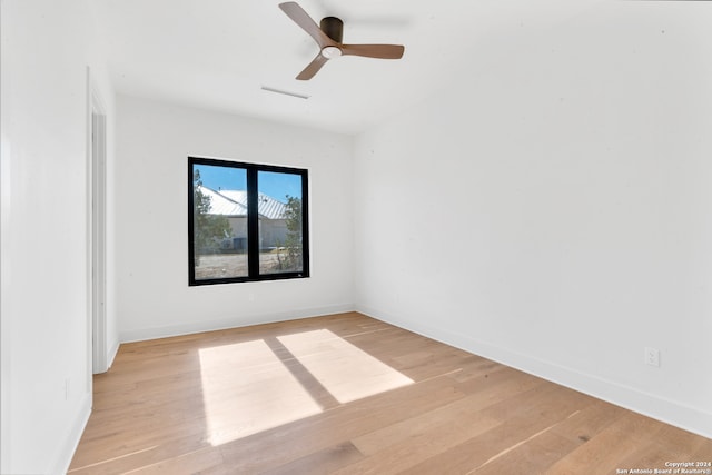 empty room with ceiling fan and light wood-type flooring