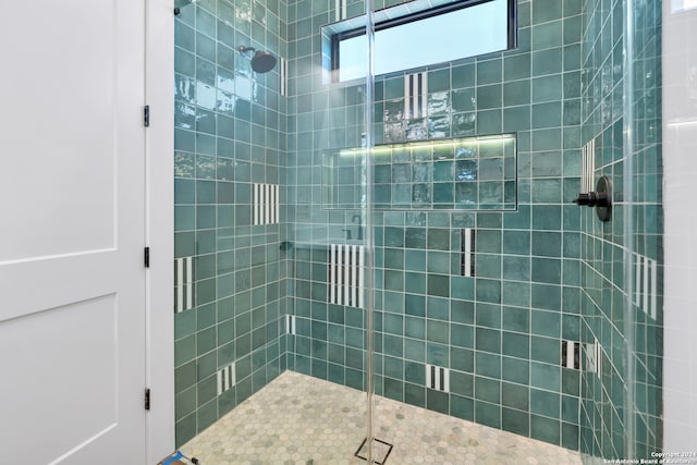 bathroom with a shower with door