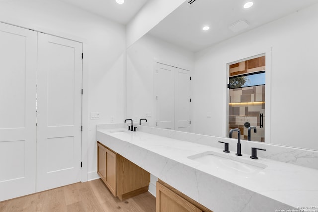 bathroom with hardwood / wood-style floors and vanity