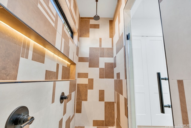 bathroom featuring walk in shower and tile walls