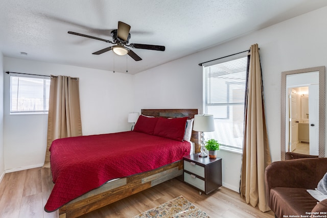 bedroom featuring ceiling fan, light hardwood / wood-style flooring, and a textured ceiling