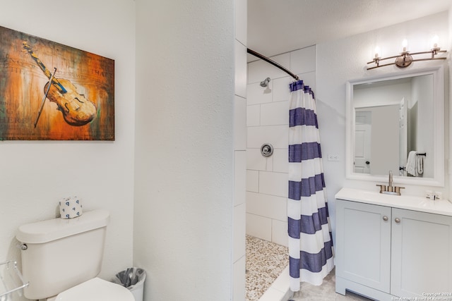 bathroom featuring curtained shower, vanity, and toilet