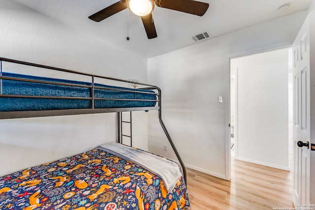 bedroom with wood-type flooring and ceiling fan