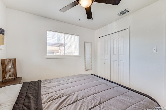 bedroom with ceiling fan and a closet