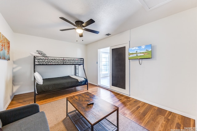 interior space with hardwood / wood-style floors, ceiling fan, and a textured ceiling