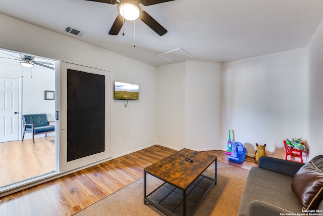 living room featuring wood-type flooring and ceiling fan