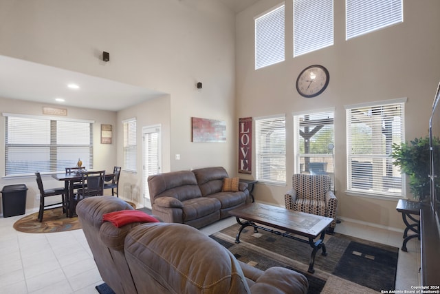 tiled living room featuring a high ceiling