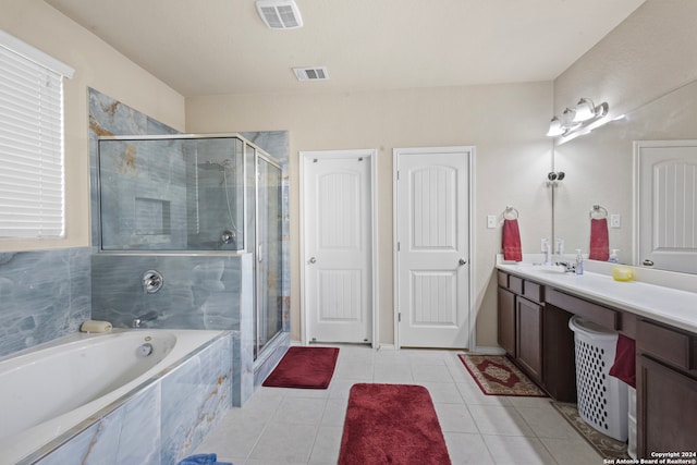 bathroom with tile patterned flooring, vanity, and shower with separate bathtub