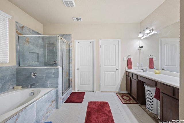 bathroom featuring tile patterned flooring, vanity, and plus walk in shower