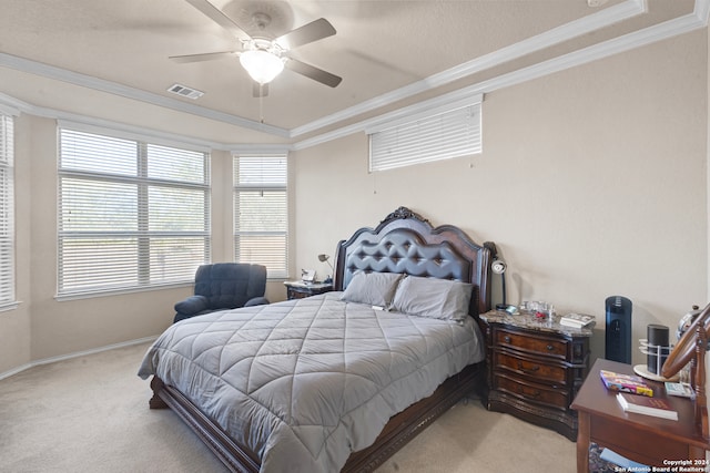 carpeted bedroom with a raised ceiling, ceiling fan, and crown molding