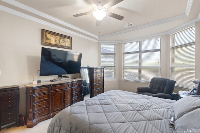 carpeted bedroom with multiple windows, ceiling fan, and ornamental molding