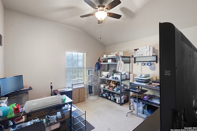 carpeted home office with ceiling fan and vaulted ceiling