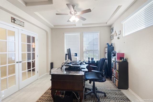 tiled office with french doors, a tray ceiling, and ceiling fan