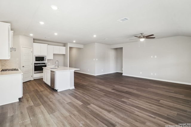 kitchen featuring a sink, appliances with stainless steel finishes, open floor plan, and ceiling fan