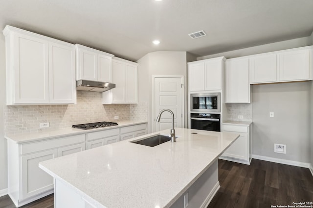 kitchen featuring visible vents, stainless steel appliances, a sink, under cabinet range hood, and white cabinetry