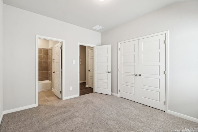 unfurnished bedroom featuring a closet, baseboards, and carpet floors