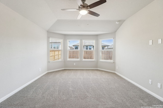 unfurnished room with baseboards, carpet, lofted ceiling, and ceiling fan