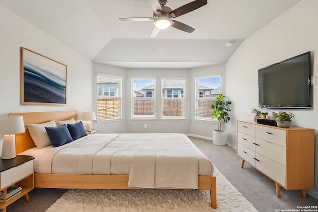 bedroom featuring lofted ceiling, multiple windows, and light carpet