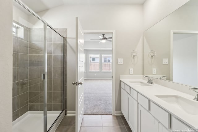 full bath featuring a sink, ceiling fan, a shower stall, and tile patterned flooring