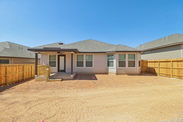 back of house featuring ceiling fan, a patio, a fenced backyard, and a shingled roof