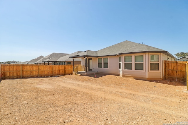 back of house featuring a fenced backyard