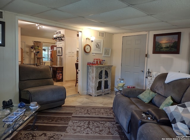 living room featuring a paneled ceiling and visible vents