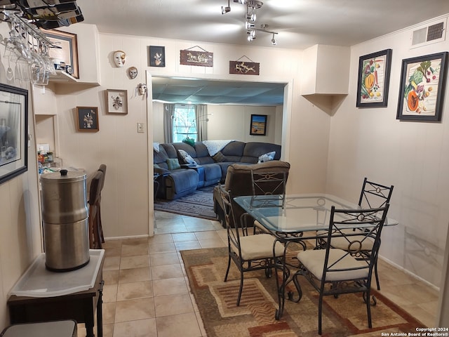 dining space with light tile patterned floors and visible vents