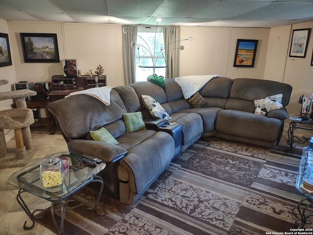 living room featuring a drop ceiling