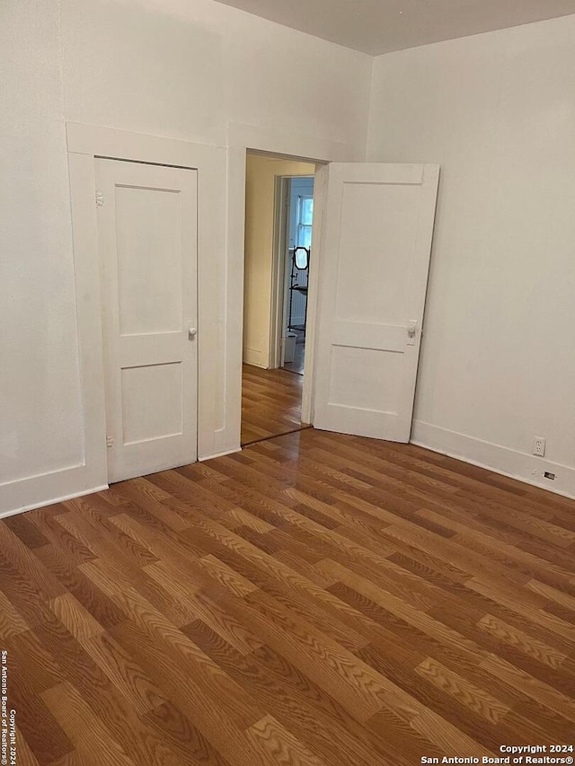 unfurnished room featuring hardwood / wood-style flooring