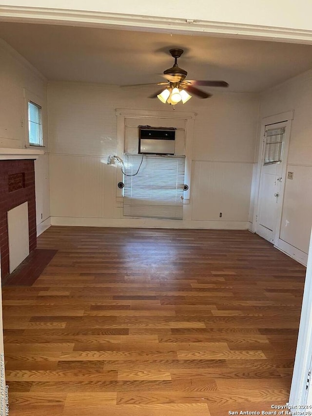 interior space featuring a fireplace, wood-type flooring, and ceiling fan