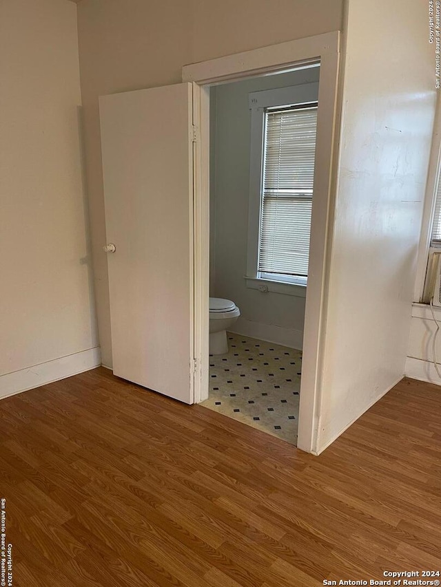 bathroom with wood-type flooring and toilet