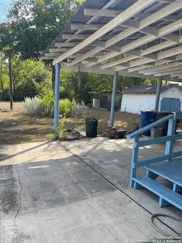 view of patio featuring a storage shed